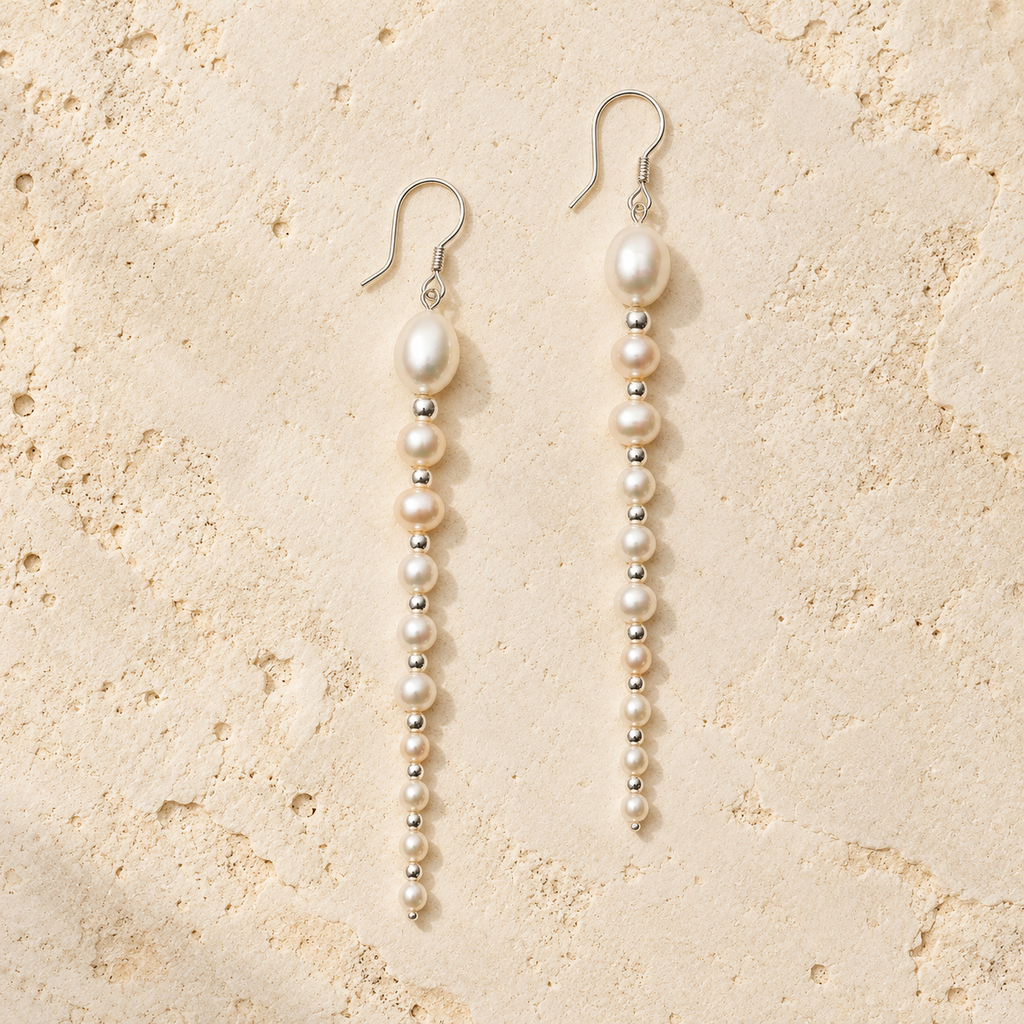 White Ripple pearl drop earrings on warm ivory stone