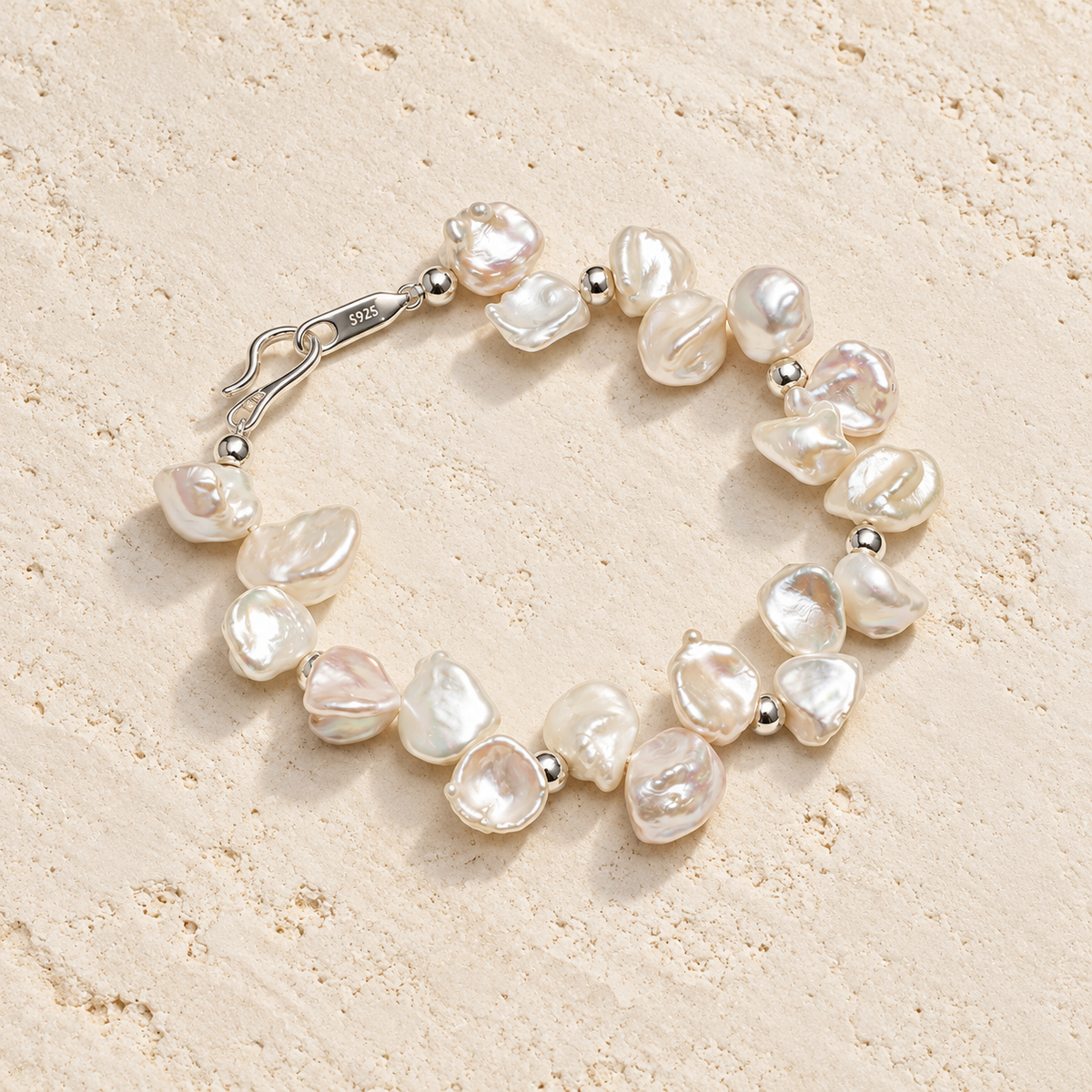 Cloud Petal pearl bracelet on warm ivory stone