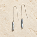 Smoky Veil gray pearl threader earrings on warm ivory stone